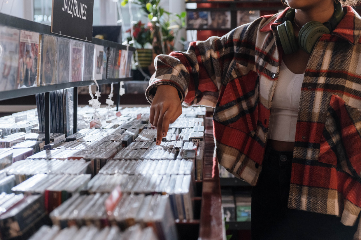 Woman with Headset Checking Audio CDs in a Music Store